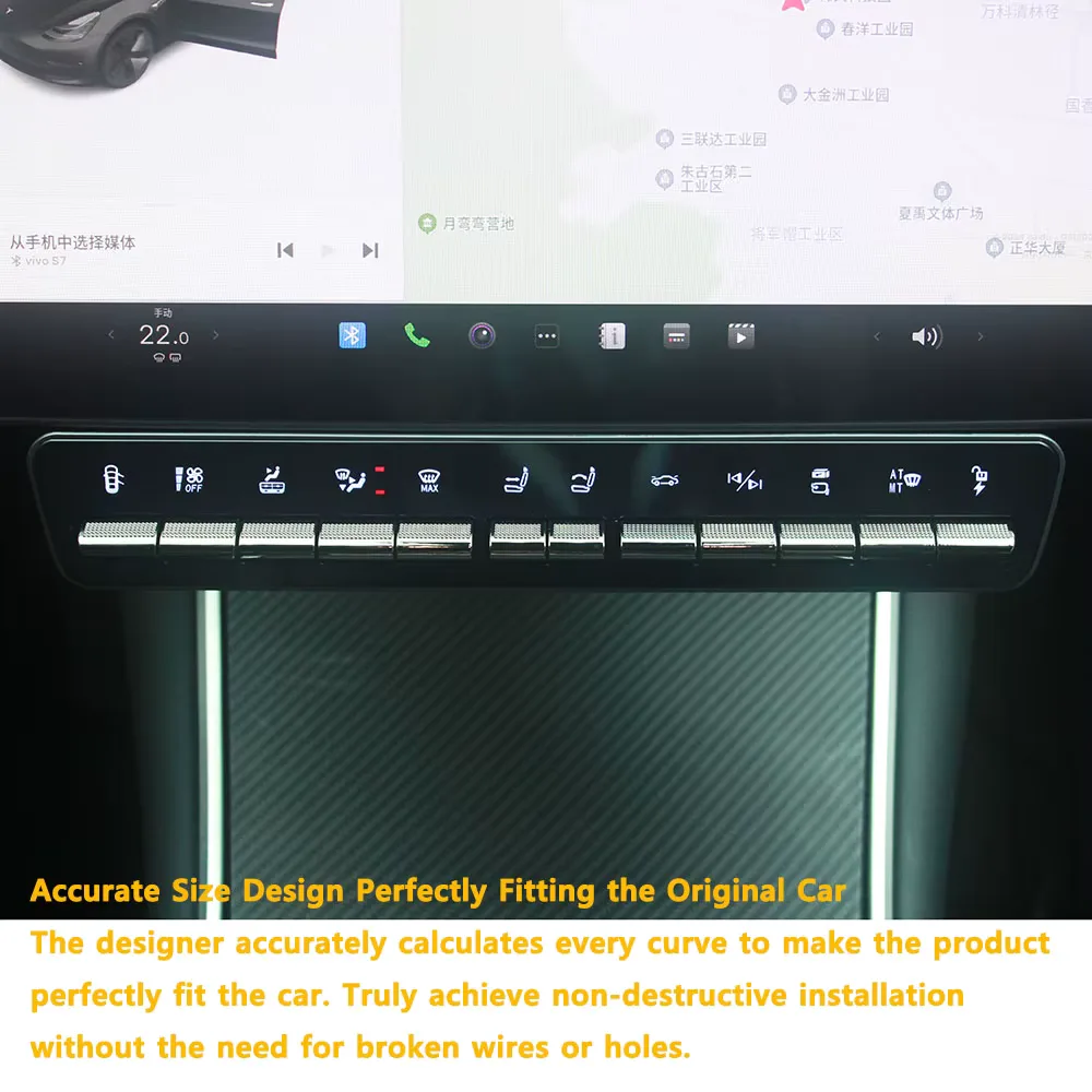 The button bar fitted below a Tesla center screen, photographed from the passenger side