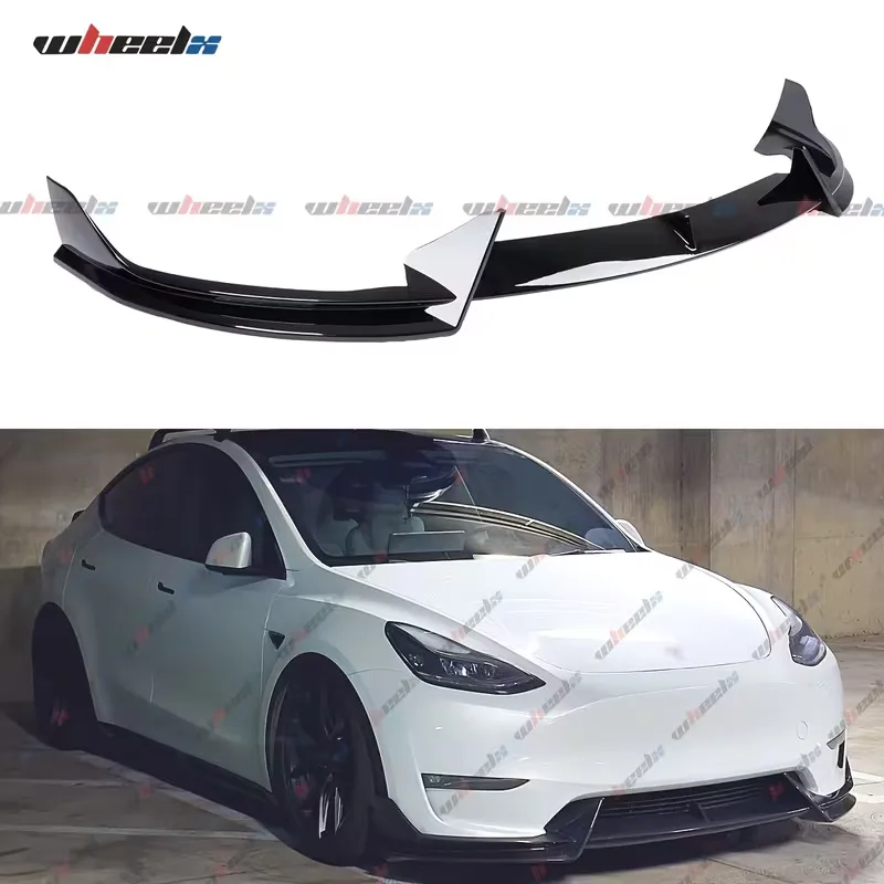 The assembled gloss black lip on white, above a white Tesla Model Y photographed from the front three-quarter with the lip fitted