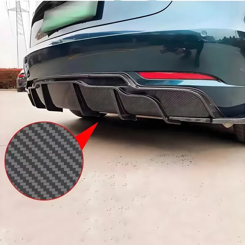 The diffuser fitted under the rear bumper of a dark blue Tesla Model 3, with a circular inset magnifying the woven carbon pattern on its surface