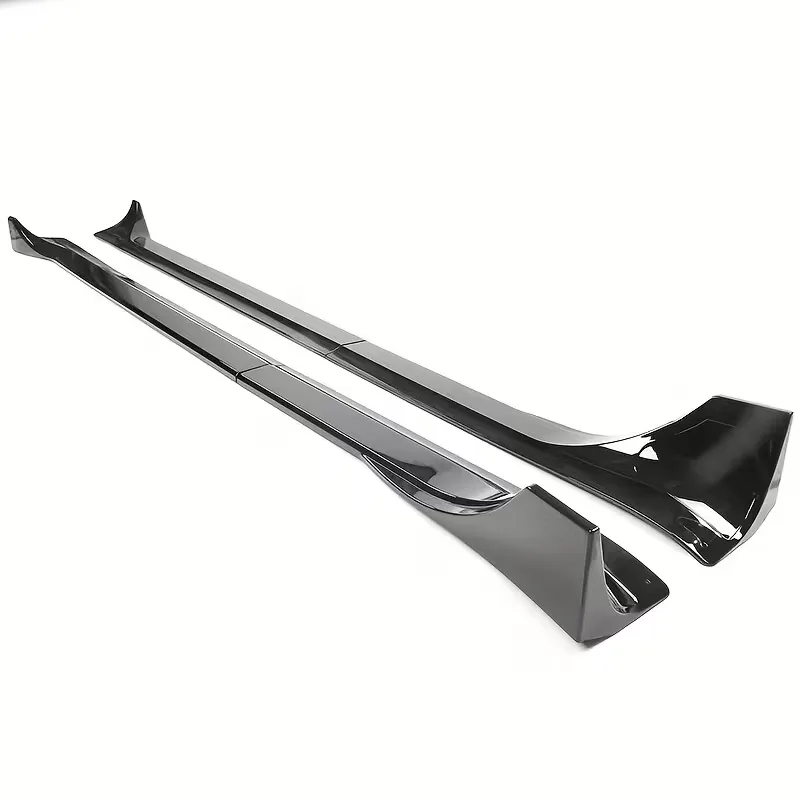 A pair of gloss black rocker extensions on white, photographed at an angle
