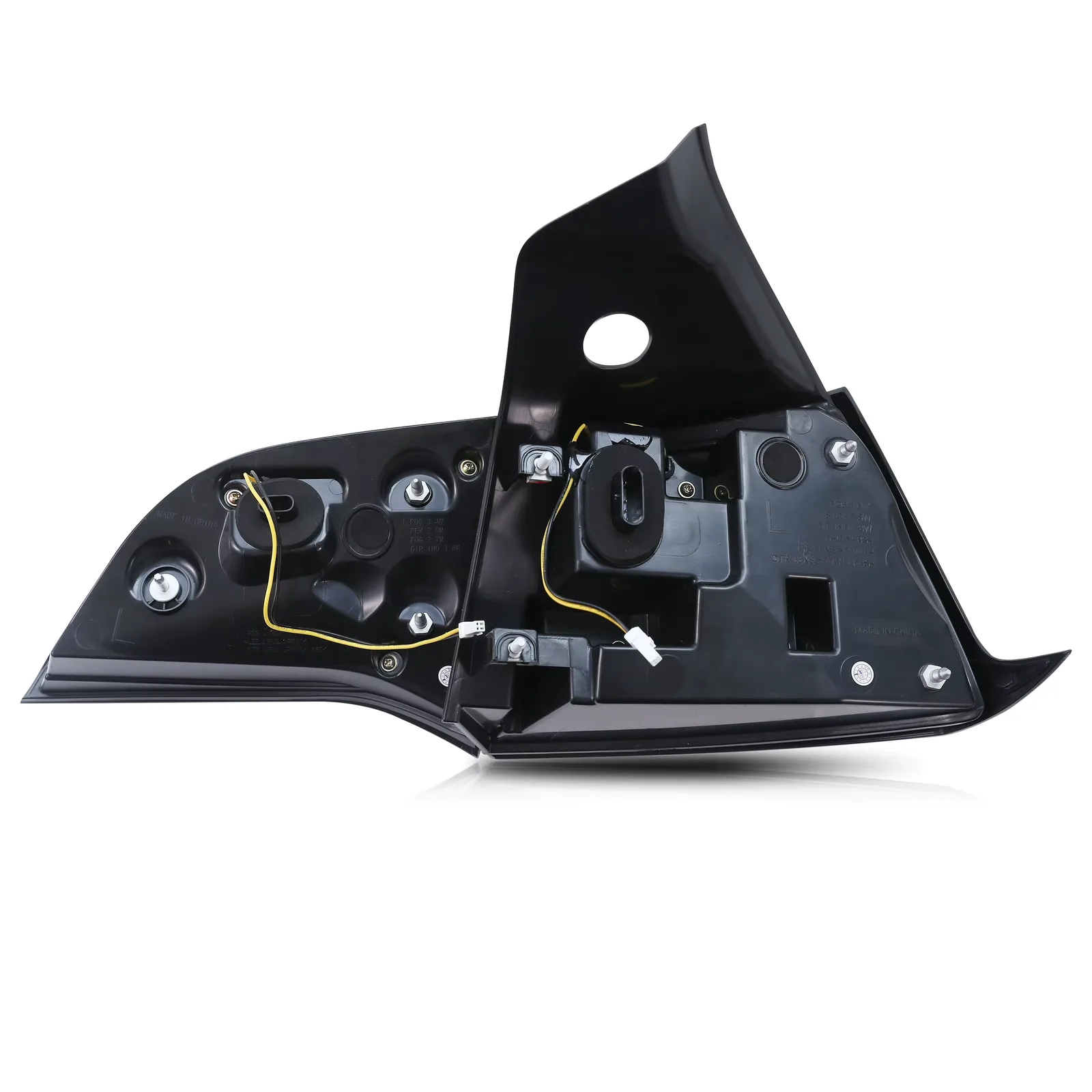 The back of one smoked tail light assembly on white, showing the mounting studs, the wiring pigtail and the molded markings