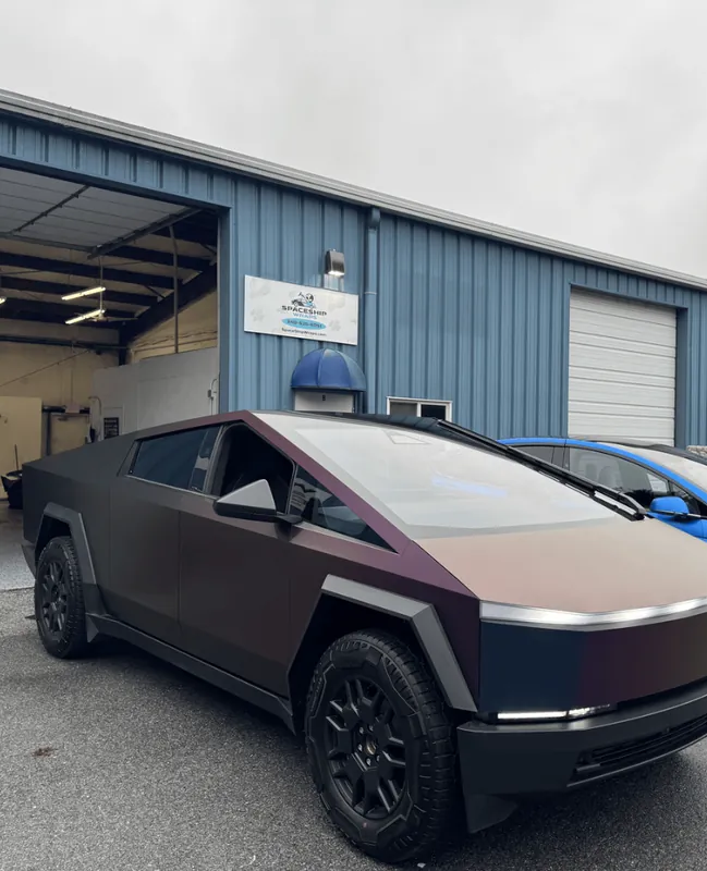 Tesla Cybertruck in a matte bronze wrap outside the shop bay