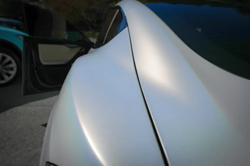 Close-up of a satin white finish running along a rear quarter panel