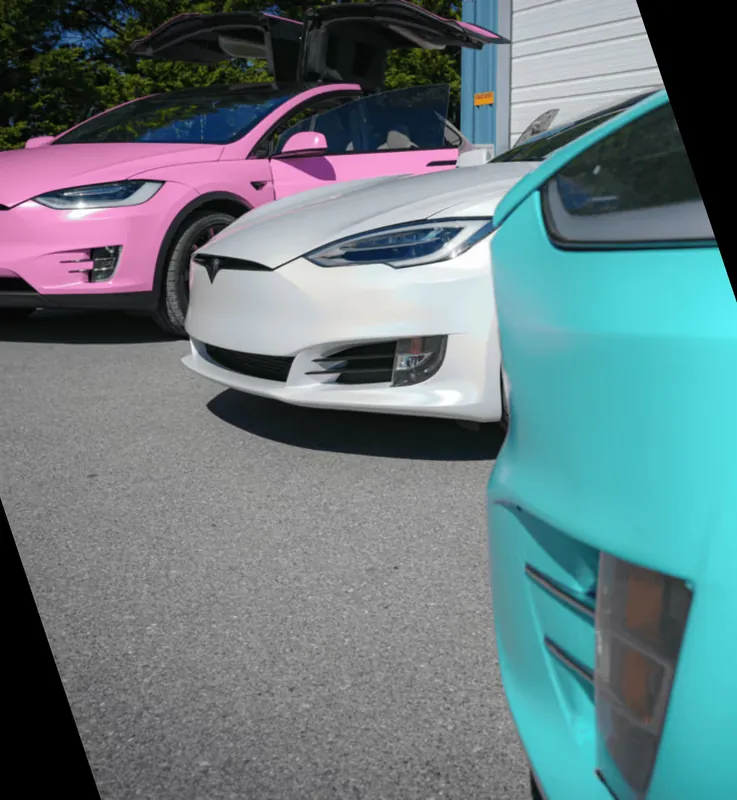 Pink Model X, satin white Model S and a teal wrapped car parked together