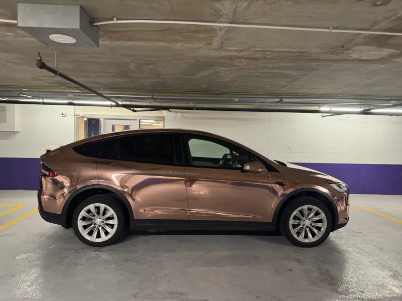 Finished Model X wrapped in rose gold chrome, full side profile