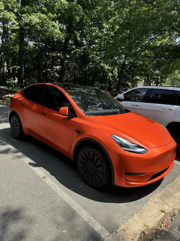 Tesla Model Y wrapped in orange, side profile
