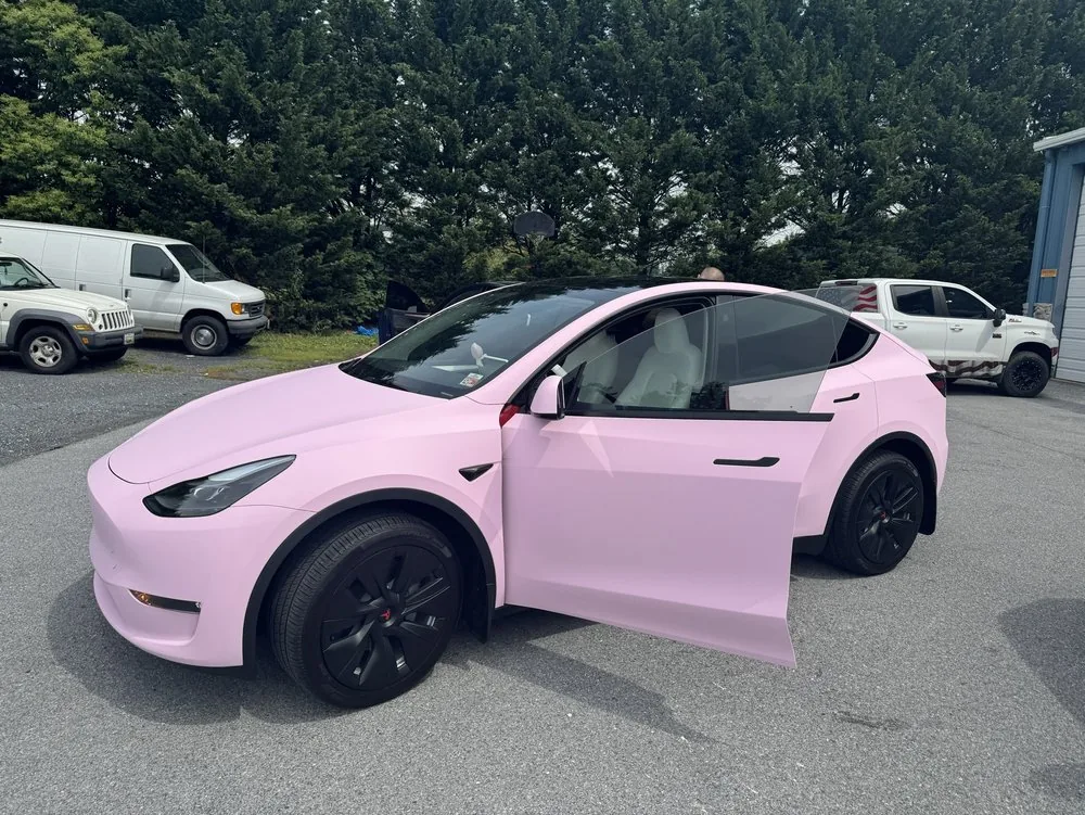 Tesla Model Y wrapped in satin pink with black wheels