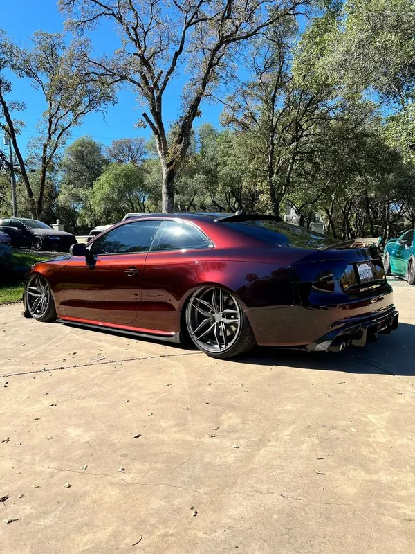 A car finished in Paradox Supreme Color PPF Diablo Red, wrapped by Paradox