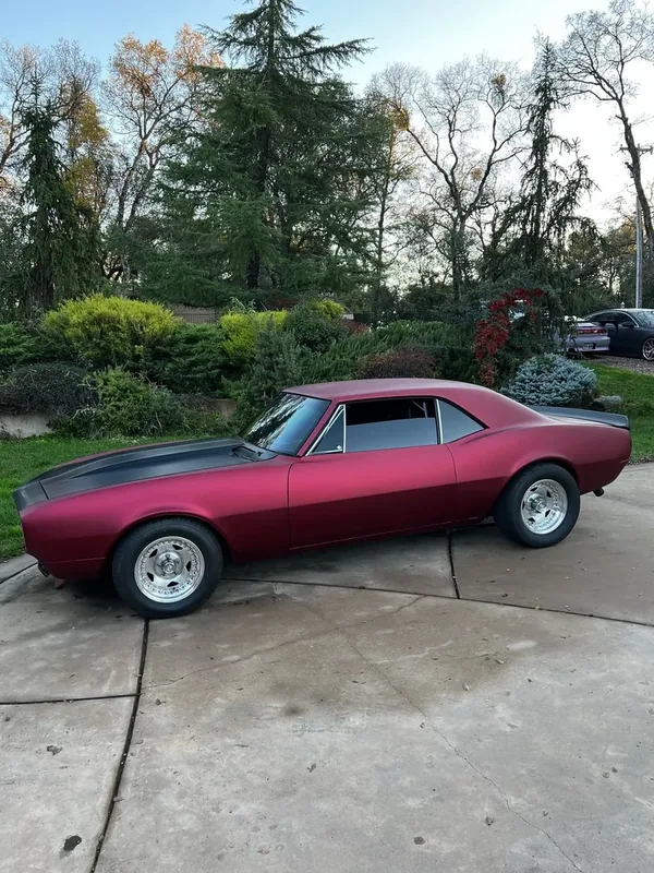 A car finished in Paradox Supreme Color PPF Satin Shadow Red, wrapped by Paradox